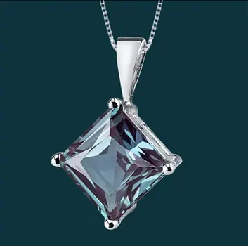 A pendant on a fine chain, lit against a deep ground.
