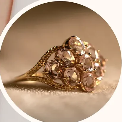 A gold ring set with stones, photographed close.