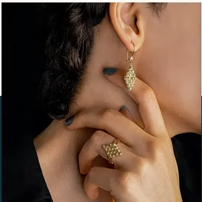 A profile with a gold drop earring.